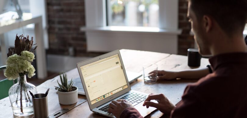 A man sits at a computer.