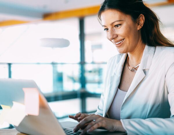 A woman sits at a computer.